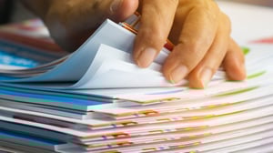 Hand leafing through documents.