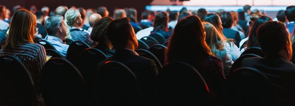 Adults at a conference attending an information session.