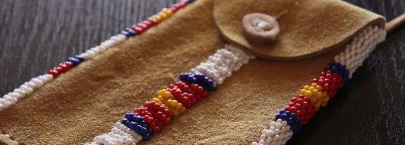 Image of a leather pouch with traditional Native American beadwork.