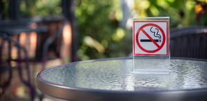 Outdoor table with a no smoking sign.