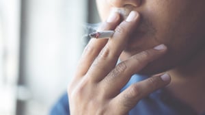 Adult male smoking a cigarette.