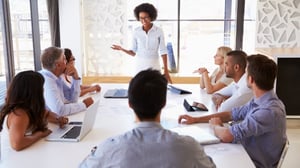 Supervisor leading a group training for her team at a table.