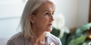 Middle ages woman with blonde hair thinking.
