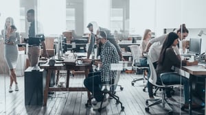 Open concept office filled with workers.